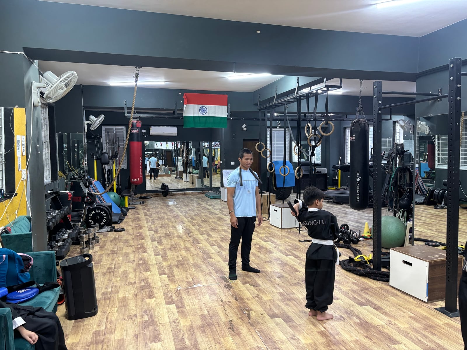 A child practising martial arts with a coach at IMFIT in Madhapur