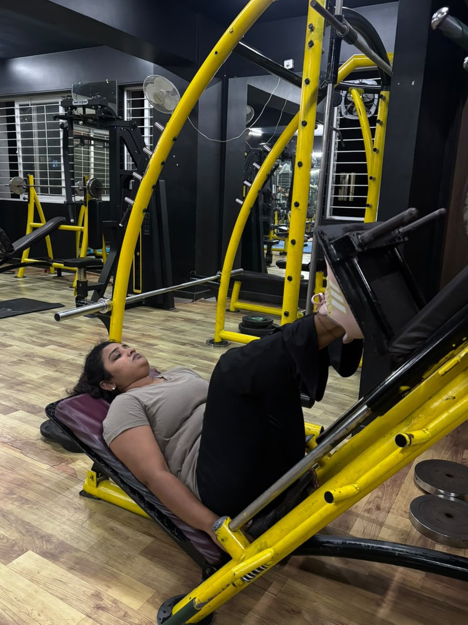Member using the leg press on IMFIT’s third floor